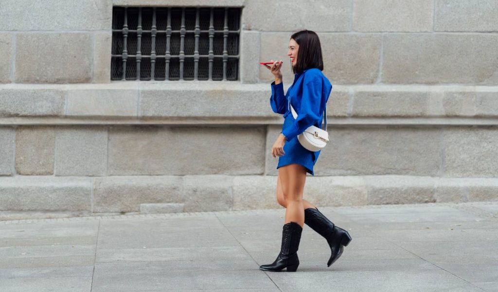 Girl using voice recognition of her phone in the street